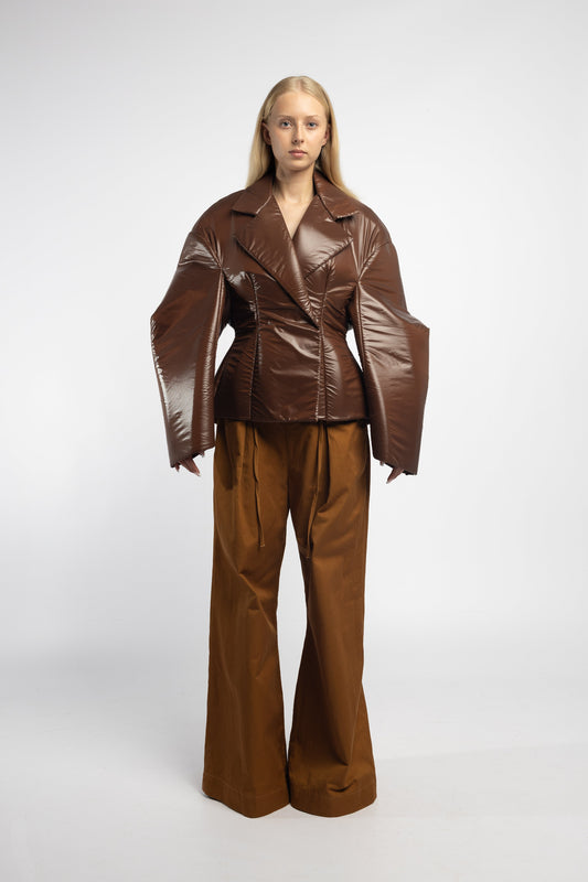 Model wearing Fitted Hybrid Puffer in chocolate with hourglass silhouette