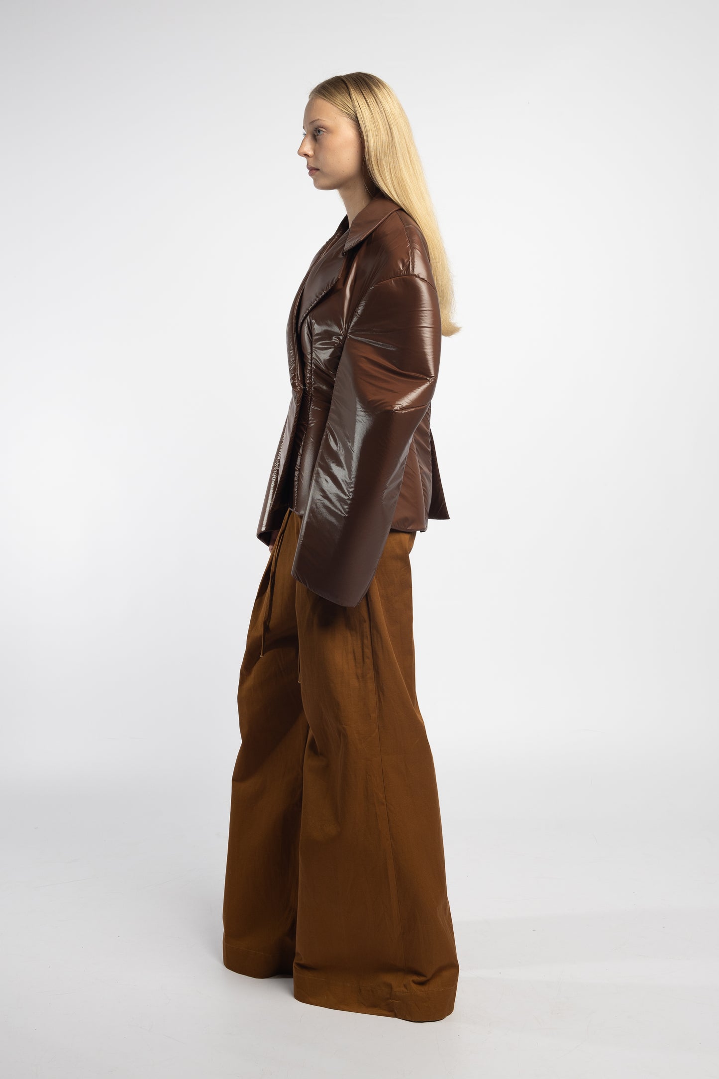 Tailored chocolate puffer jacket with sculptural darted sleeves