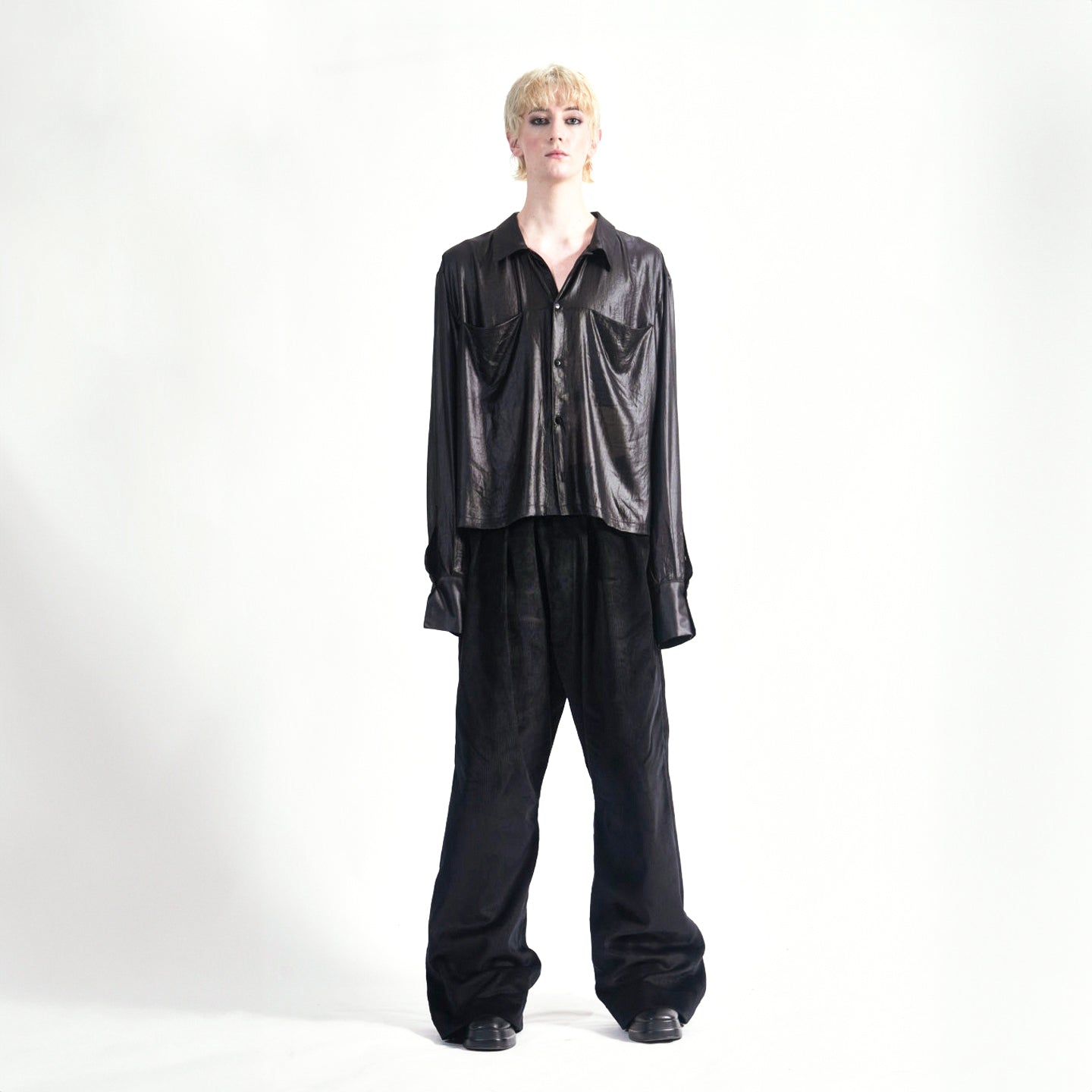 Front view of the Marq Shirt in Liquid Black highlighting the sleeve drape detail and front button closure, front inseam pockets.1.