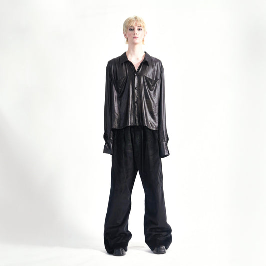 Front view of the Marq Shirt in Liquid Black highlighting the sleeve drape detail and front button closure, front inseam pockets.1.