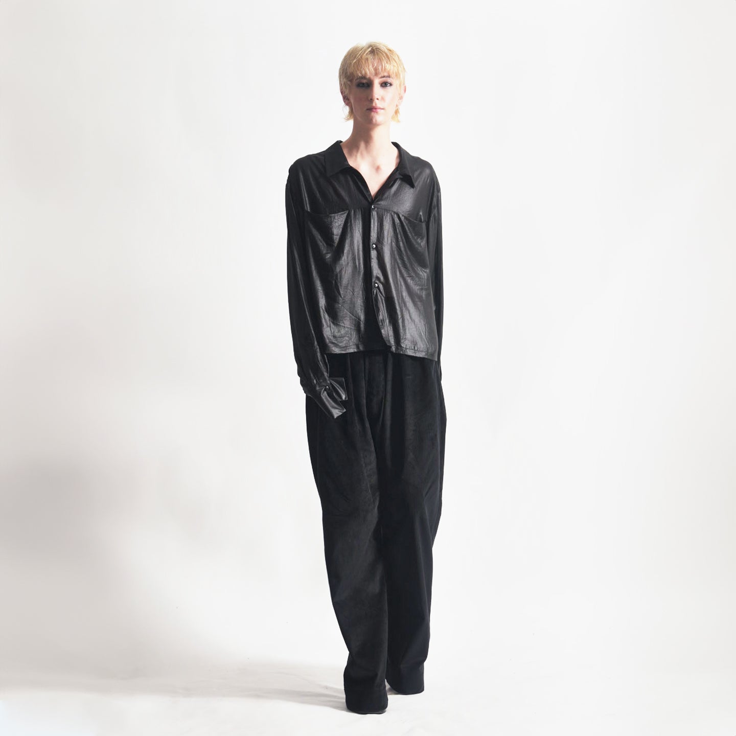 Front view of the Marq Shirt in Liquid Black highlighting the sleeve drape detail and front button closure, front inseam pockets.