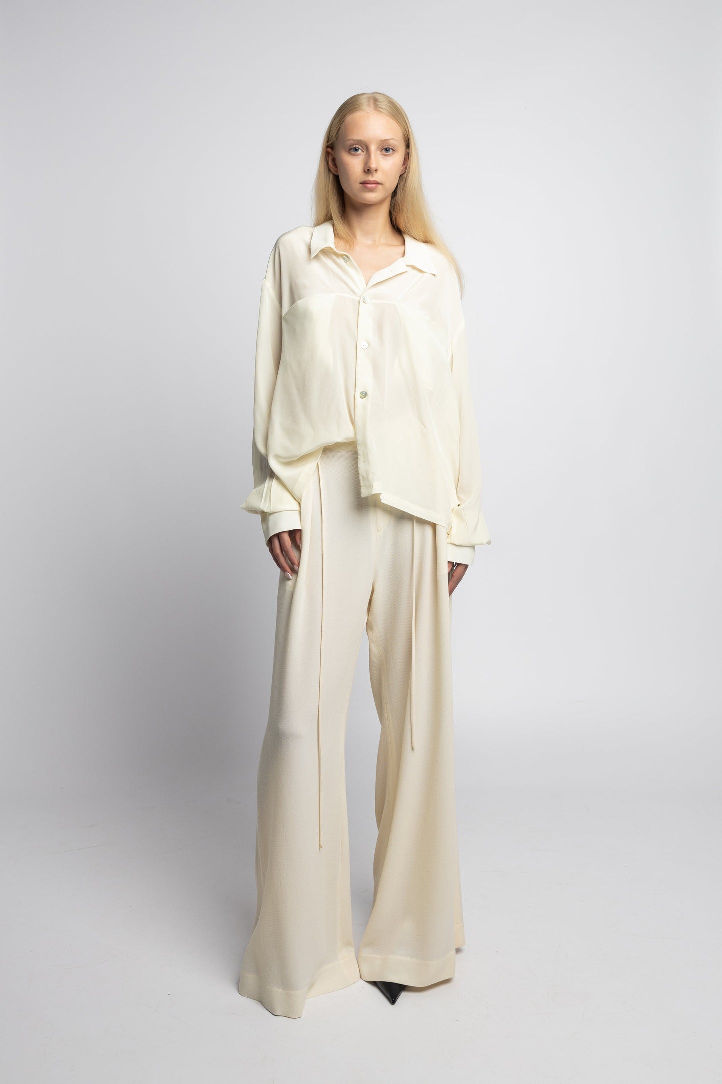 Model wearing Marq Shirt in pearl silk with bold cuffs