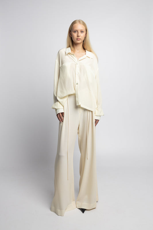 Model wearing Marq Shirt in pearl silk with bold cuffs