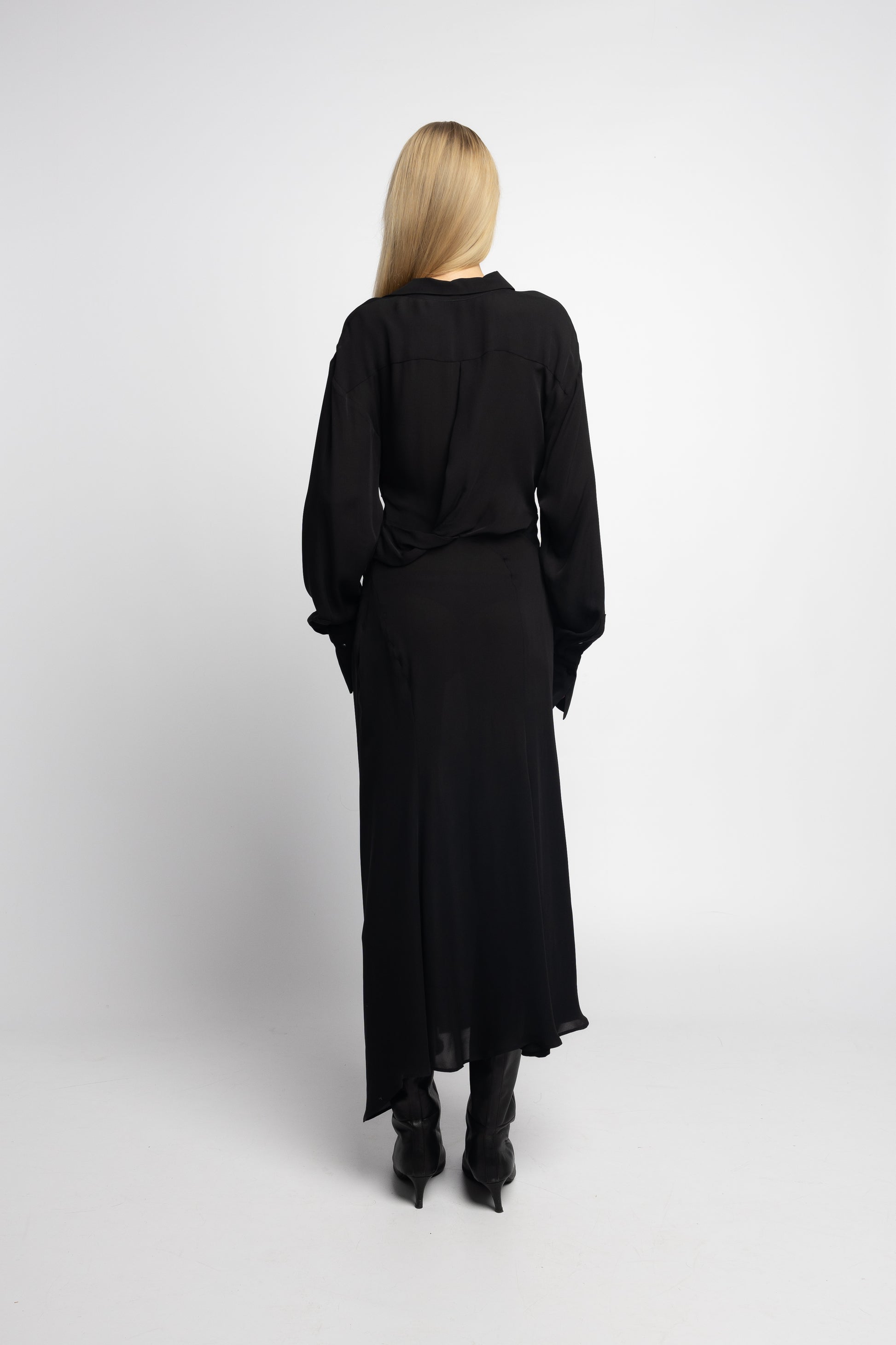 Back view of black silk dress with twist detail