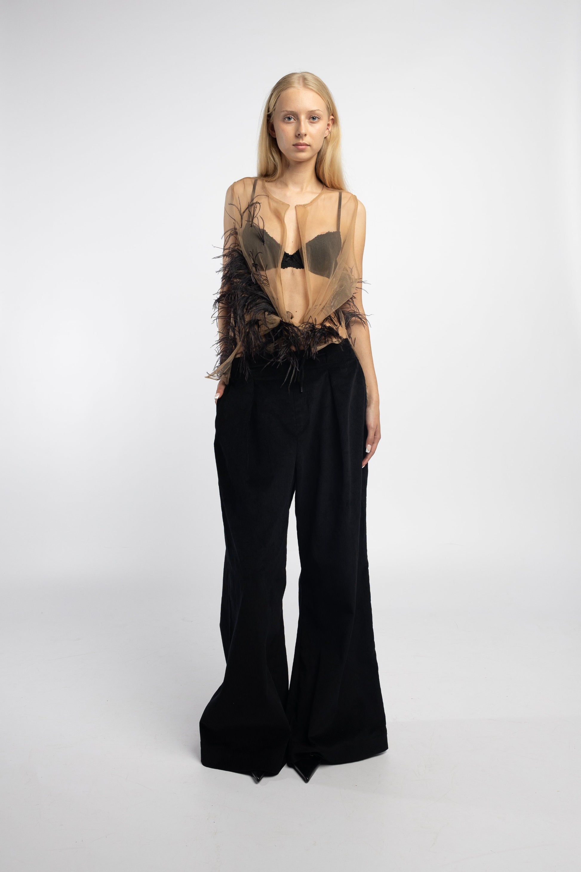 Model wearing Nude Feather Mesh Blouse with hand-stitched ostrich feathers