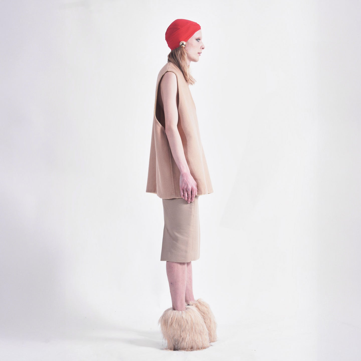 Tan Side view of reversible oversized wool vest with soft brushed texture and hand finishing, highlighting the relaxed fit and design.2.