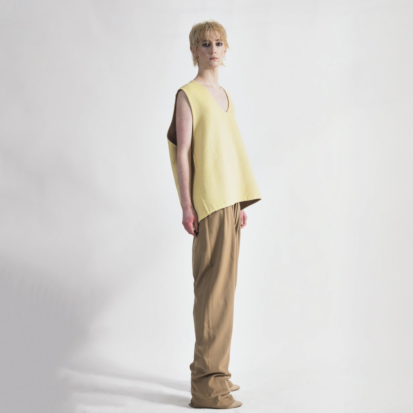 Lemon Side view of reversible oversized wool vest with soft brushed texture and hand finishing, highlighting the relaxed fit and design.