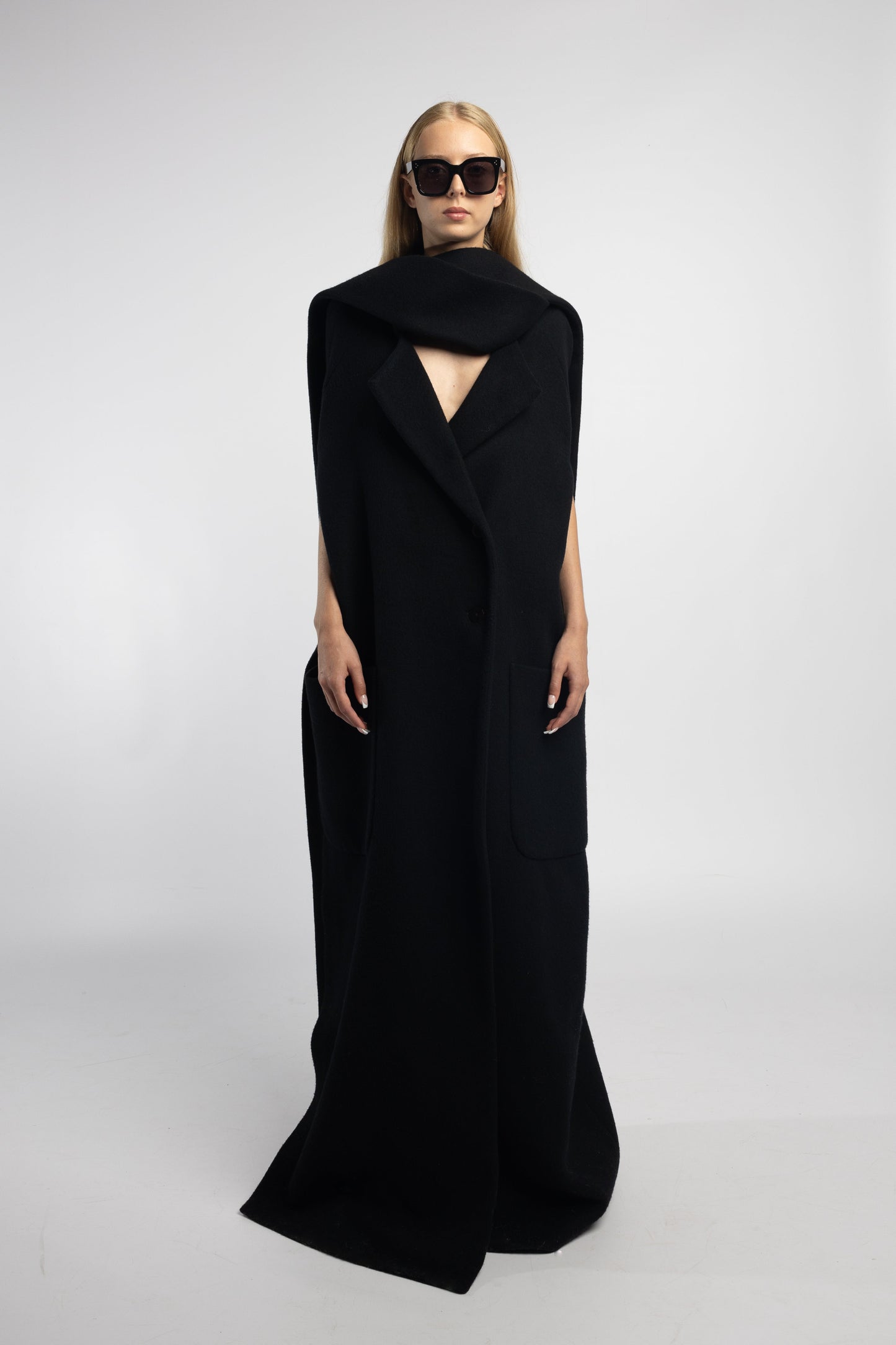 Model wearing black Scarf Collar Coat with dramatic scarf collar and long back vent