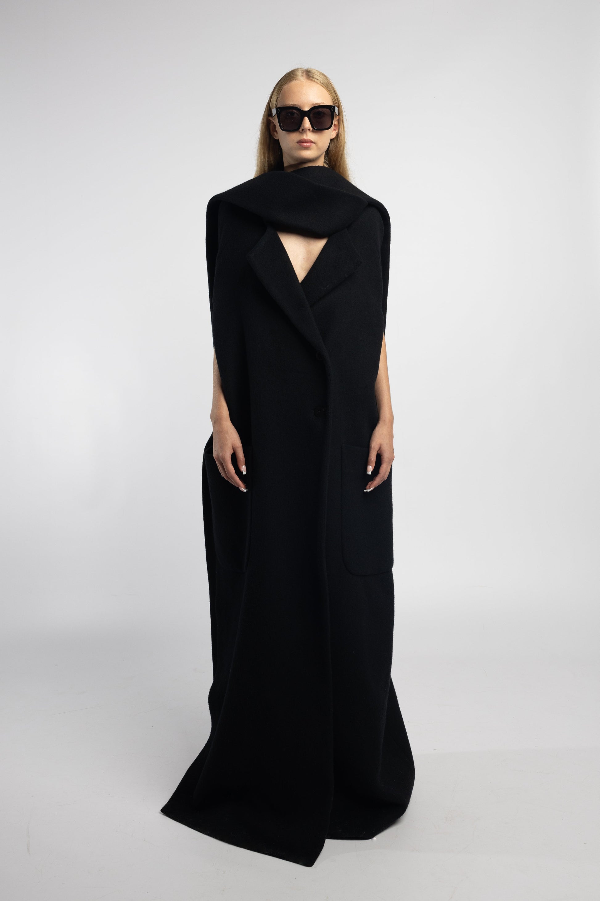 Model wearing black Scarf Collar Coat with dramatic scarf collar and long back vent