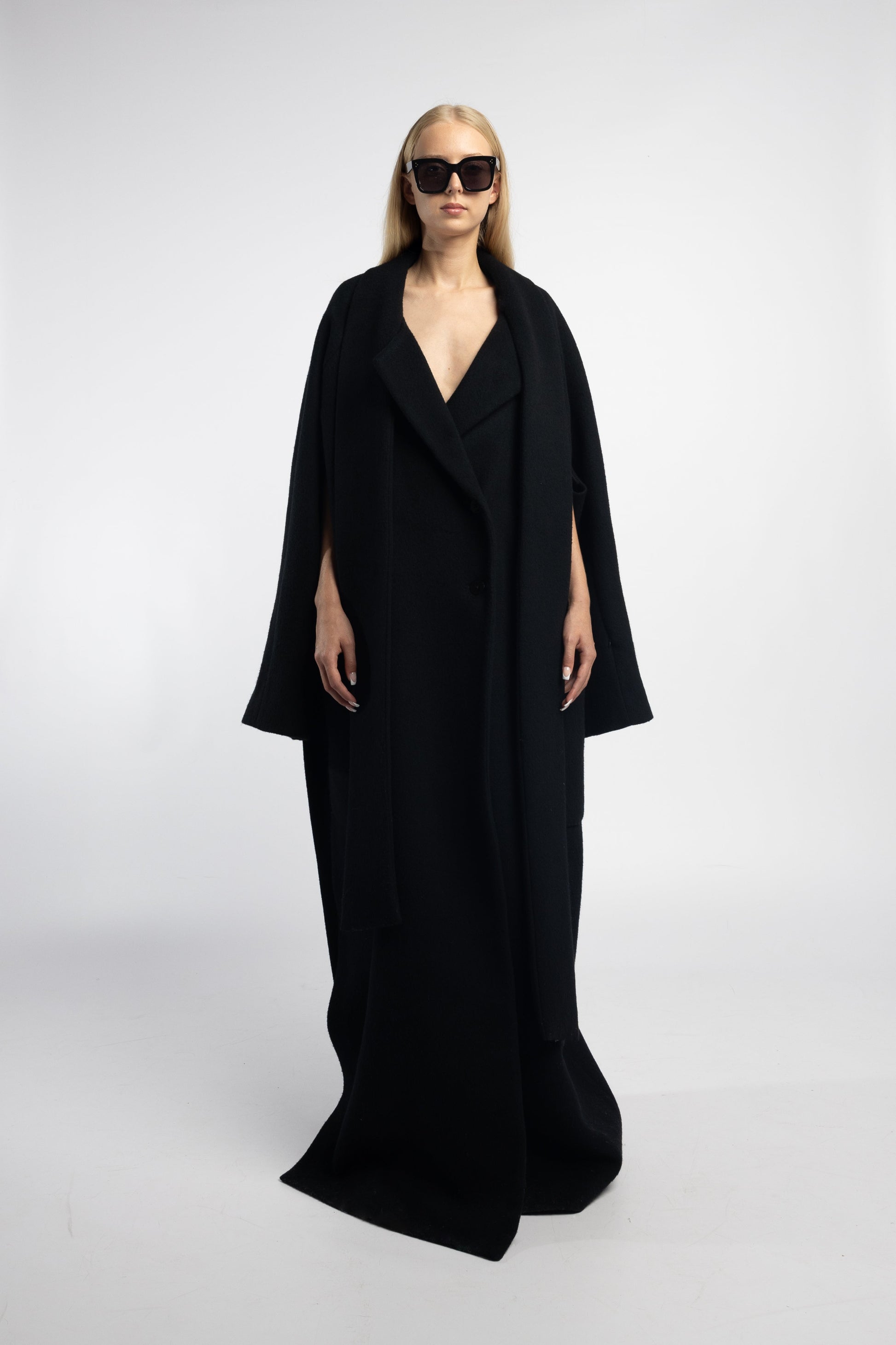 Black floor-length coat with three sleeve options and patch pockets