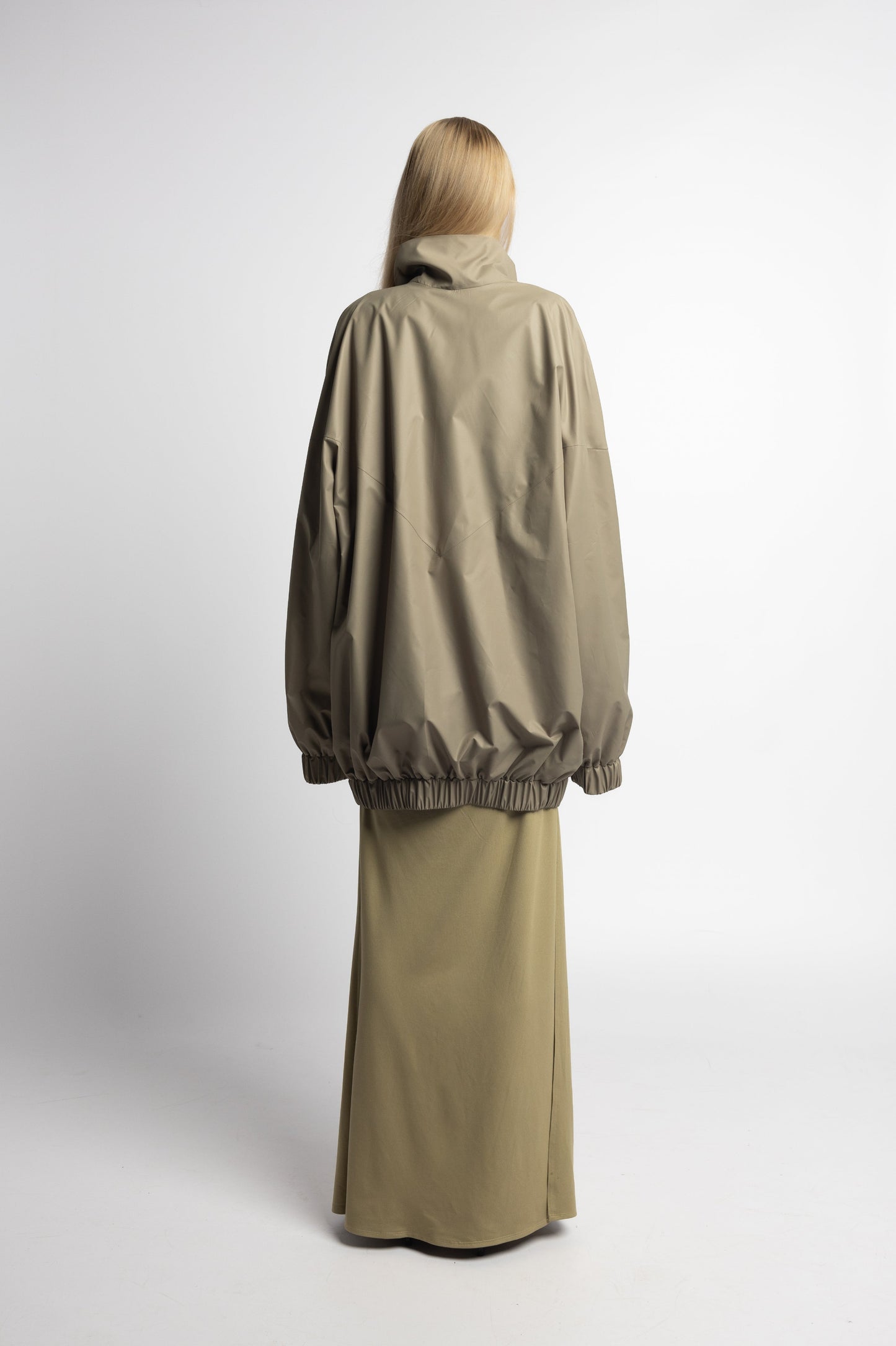 Back view of model in sage Youhan Jacket