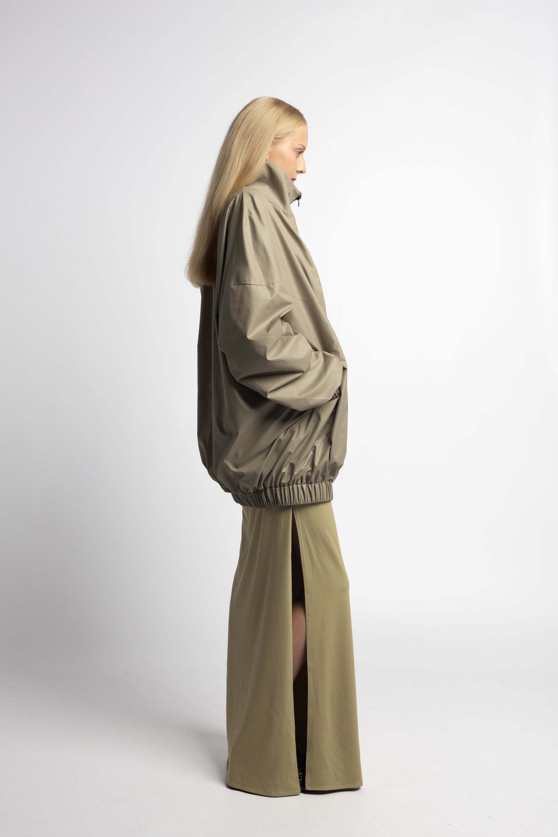 Lightweight sage green nylon windbreaker with deep front pockets