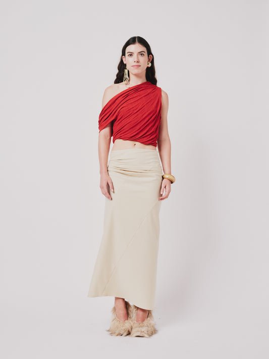 Woman wearing a top and structured draped skirt in pear sorbet.  Front view