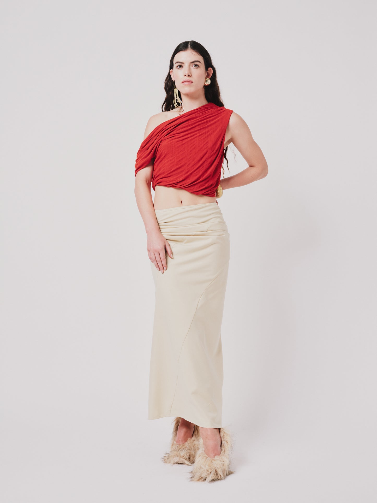 Woman wearing a top and structured draped skirt in pear sorbet. Front view