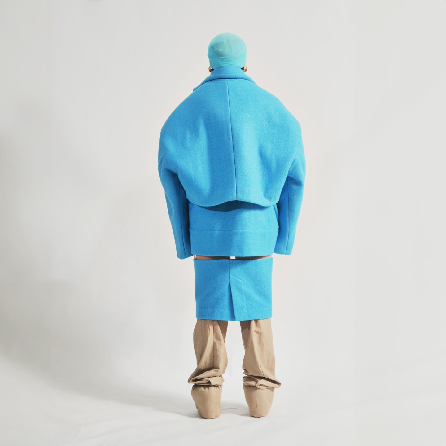 Back view of the Hoffman Hybrid Puffer jacket in colour Vivid Cerulean displaying its structured fit and Wool outer layer.