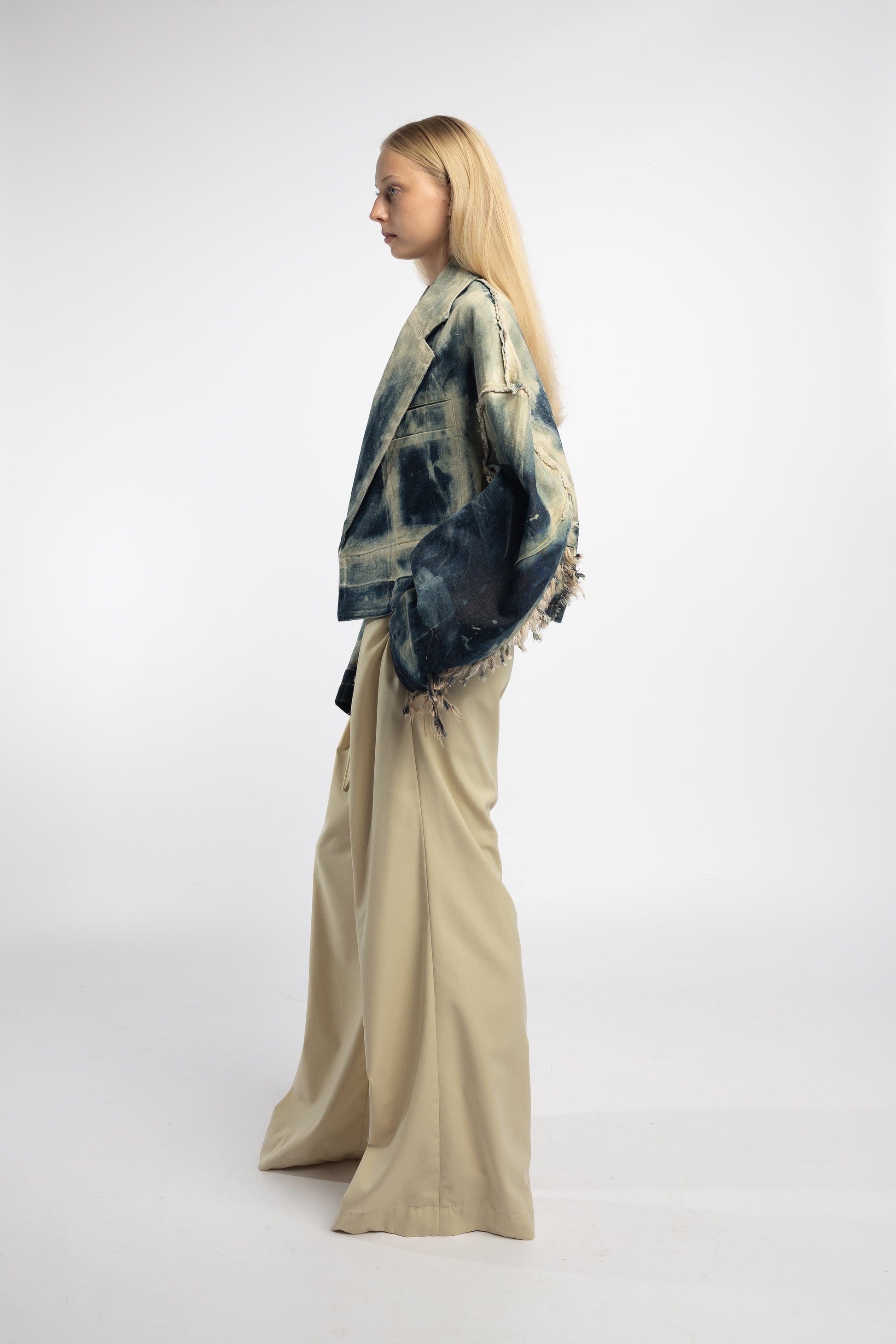 Hand-distressed blue denim jacket with cropped silhouette