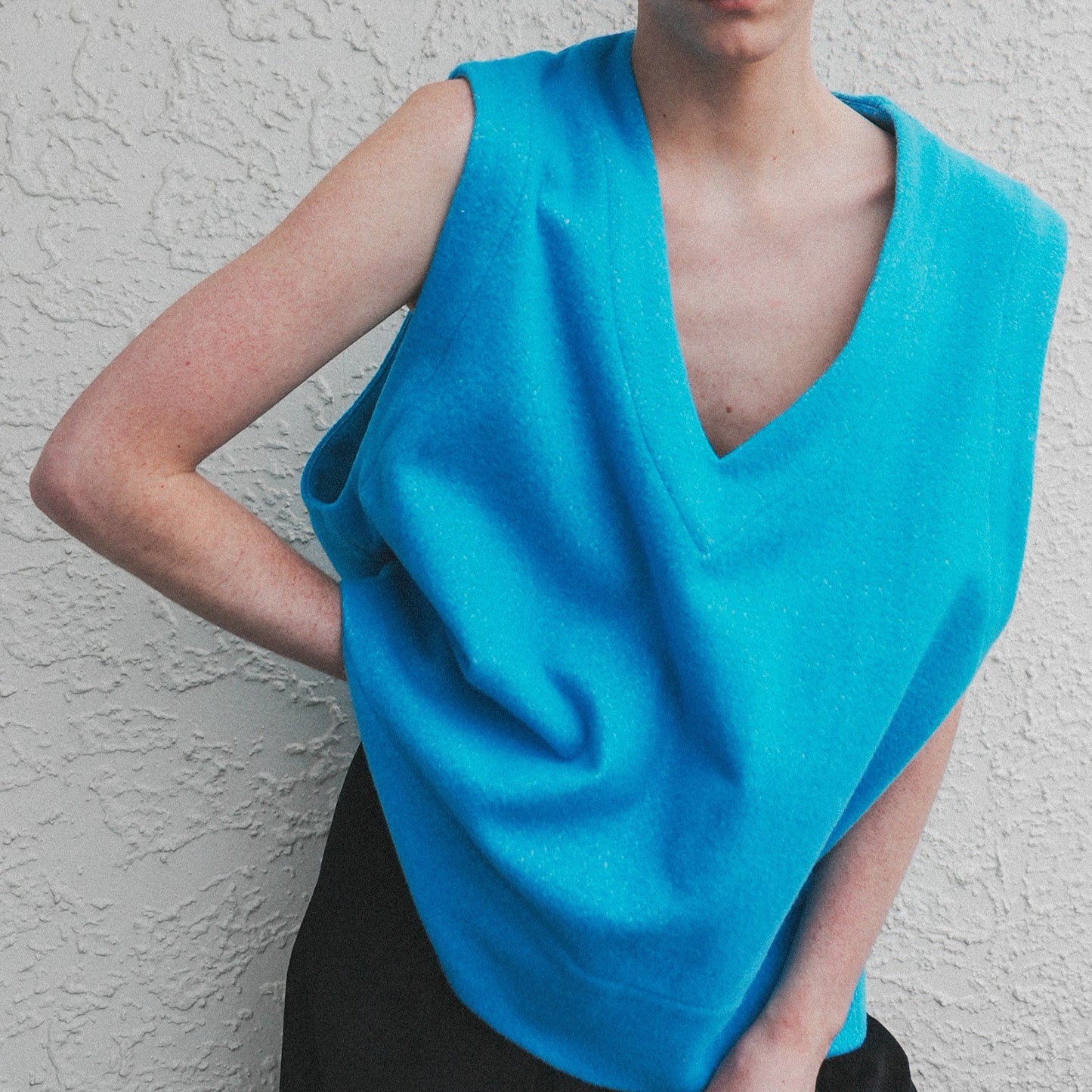 Model Lachy wearing the Vivid Cerulean Blue oversized wool vest with soft texture , styled over casual outfit