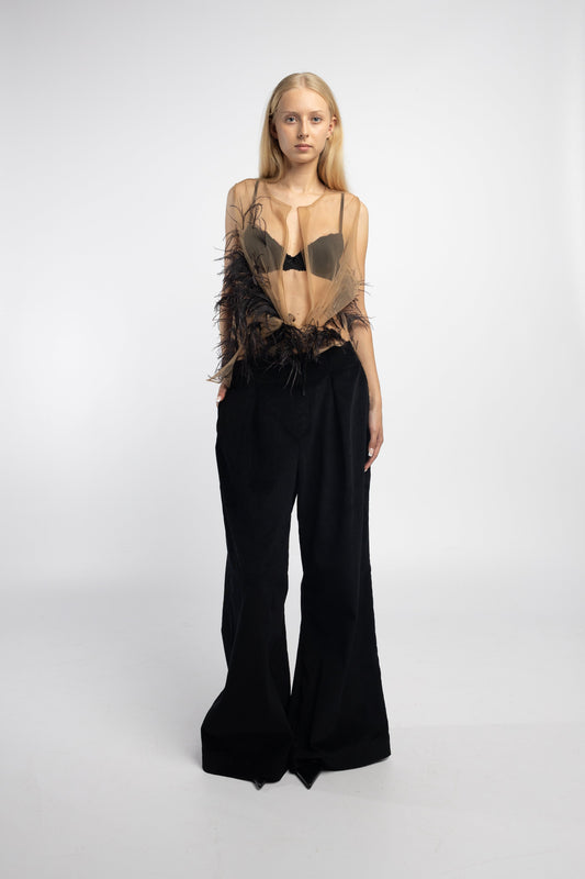 Model wearing Nude Feather Mesh Blouse with hand-stitched ostrich feathers