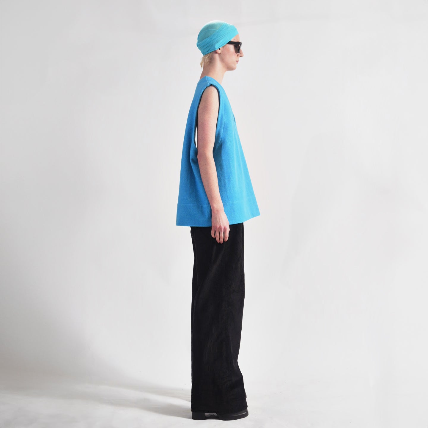 Vivid Cerulean Blue Side view oversized wool vest with soft  texture , highlighting the relaxed fit and design.