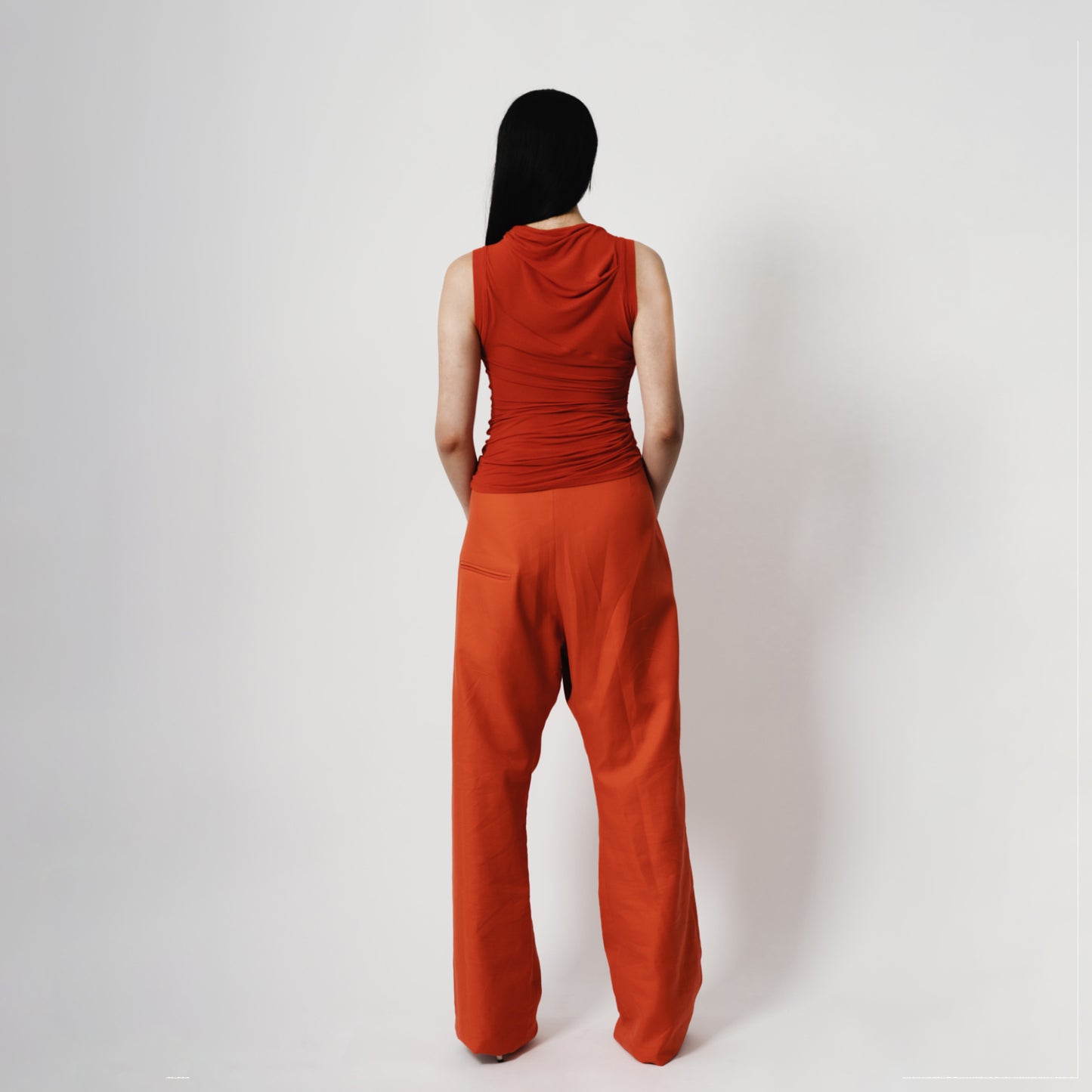 Slightly Sheer Mandarin/Orange draped top knit fabric. Back view . made in New Zealand